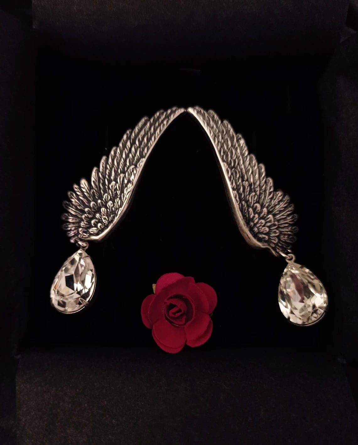 Silver wing ear climbers with clear crystal drops.