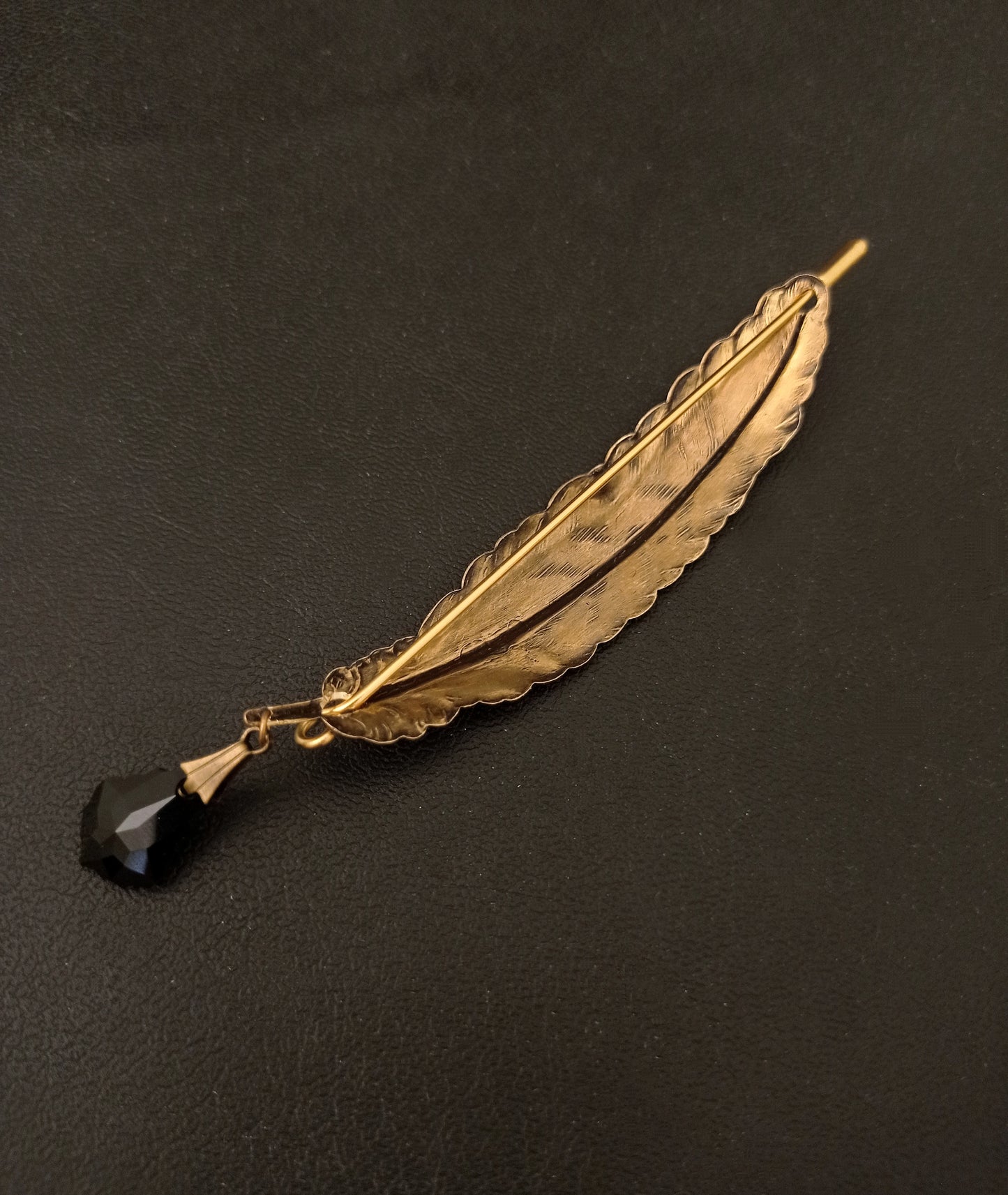 Brass quill brooch with black crystal "ink" drop.