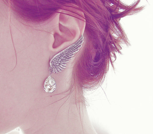 Elegant silver earrings designed as delicate wings with crystal drops, exuding a sense of grace and sophistication.
