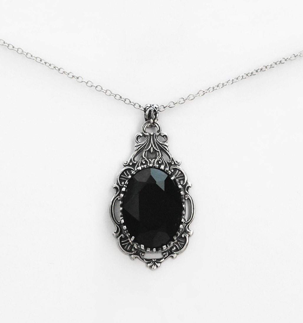 Make an elegant statement with this beautiful Victorian Gothic necklace. The oval crystal jewel is nested in a crown shaped setting and an oblong dainty frame giving it depth and substance. Comes in several colours. Victorian Gothic jewelry by Aranwen.