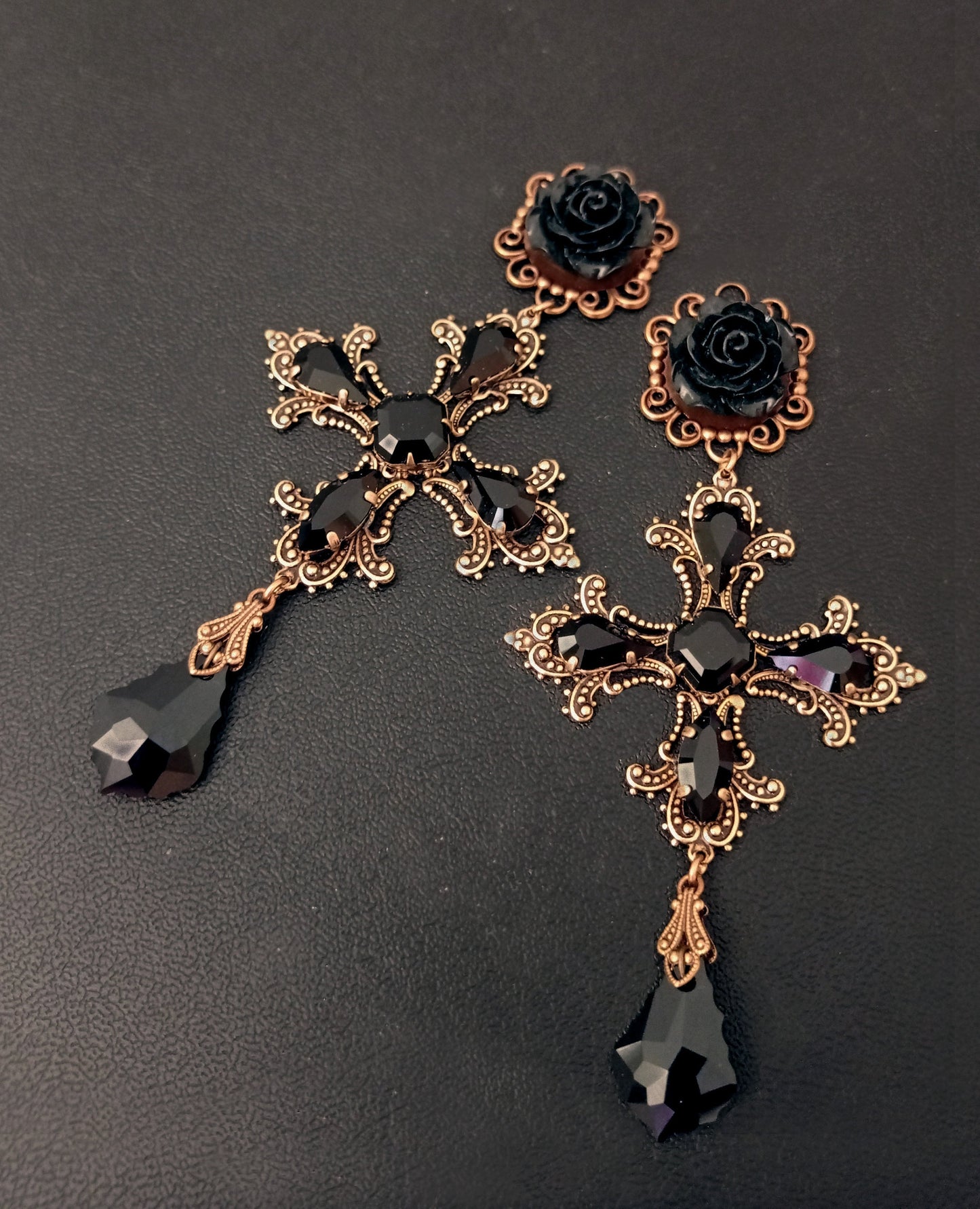 Large statement earrings inspired by Dolce and Gabbana's black and gold style! Detailed gold crosses have their edges accentuated by pointy black crystals with a black rose in the centre.