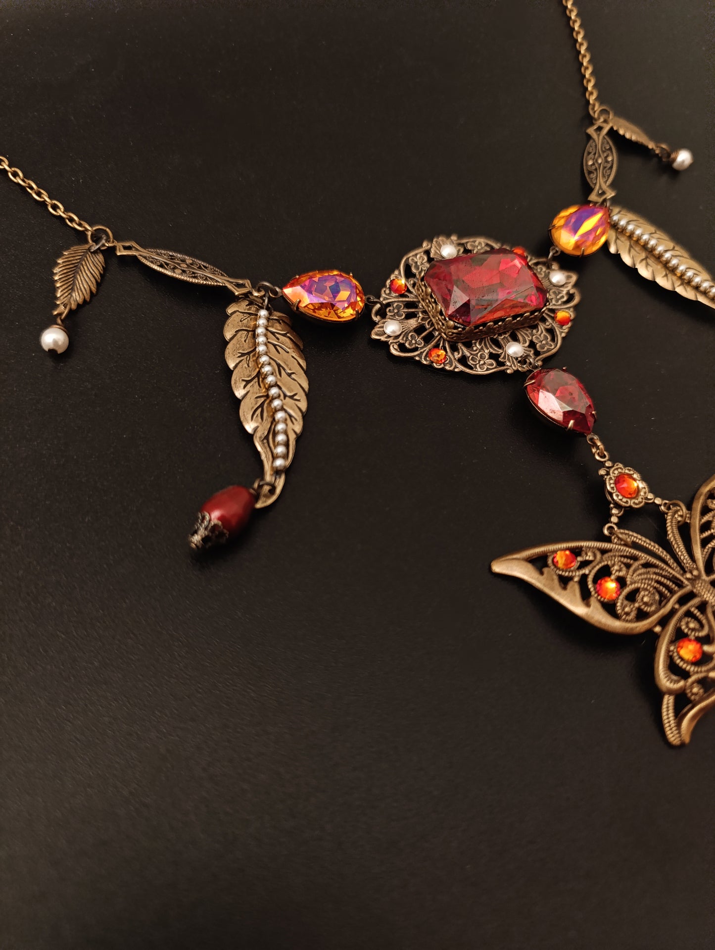 Brass filigree butterfly and red crystals necklace