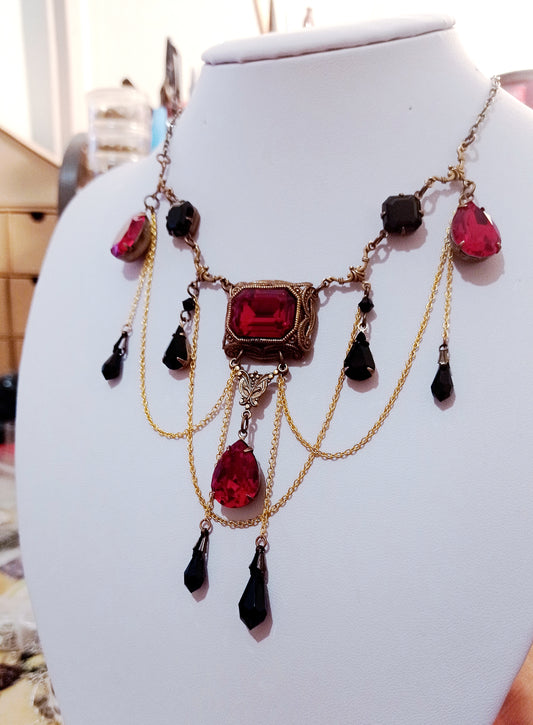 Brass bib necklace with red crystals