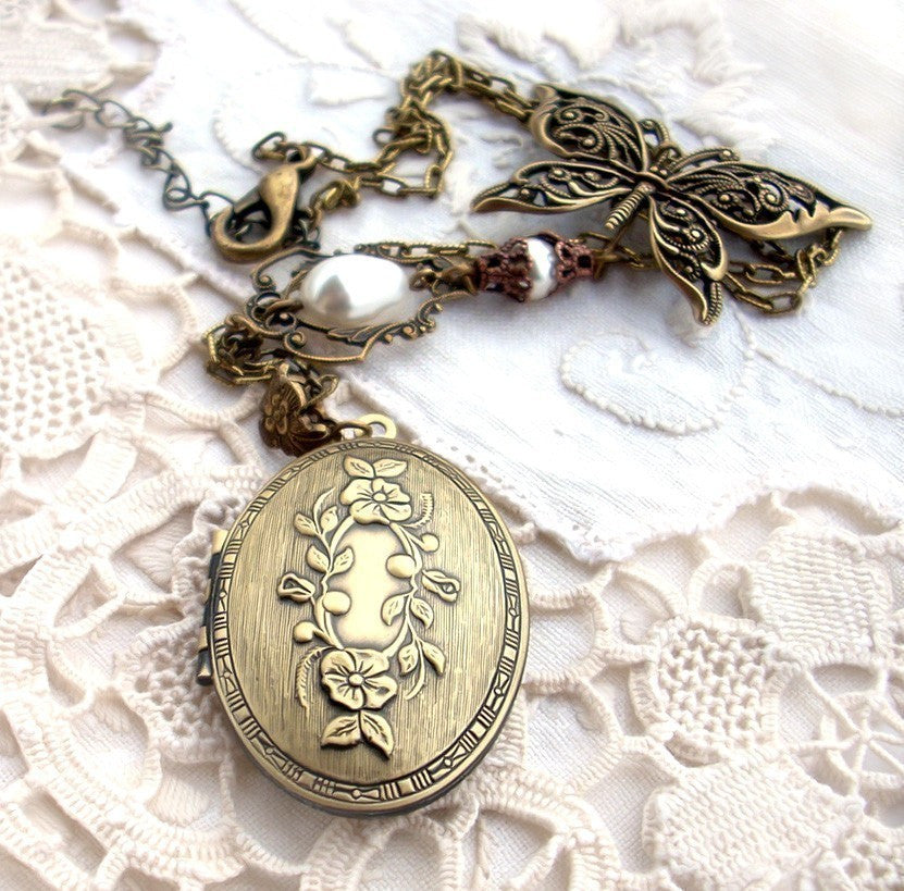 Vintage style brass locket necklace adorned by a filigree butterfly and cream white crystal pearls, nickel and lead free. Vintage style romantic jewelry by Aranwen.